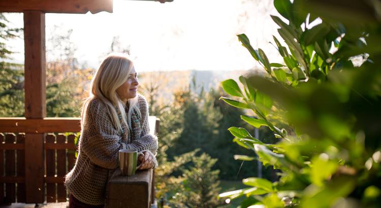 Photo of a woman looking off the back of her deck