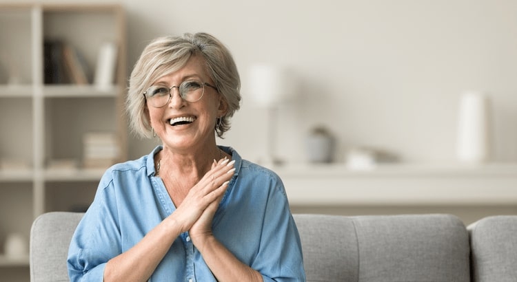 Older woman on couch smiling