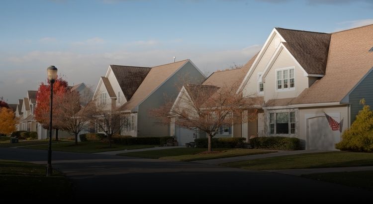 Photo of a neighborhood street with a couple of houses