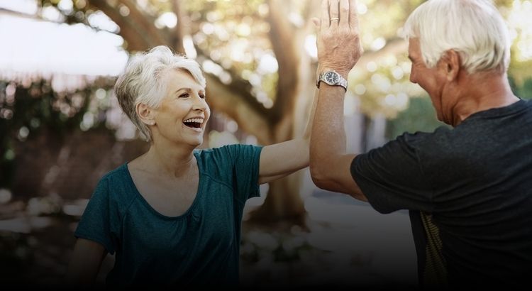 Two retired people high fiving each other