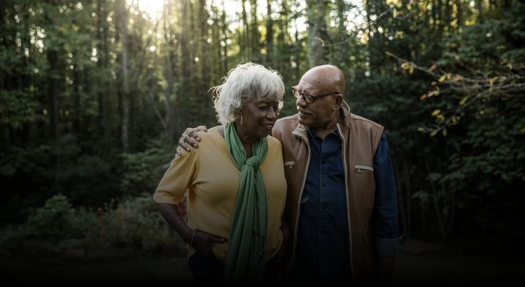 Older couple walking in the woods
