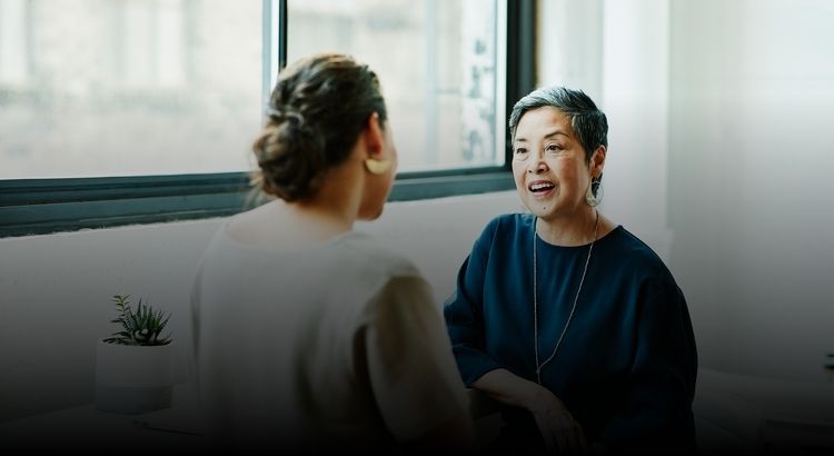 Two women sitting and talking