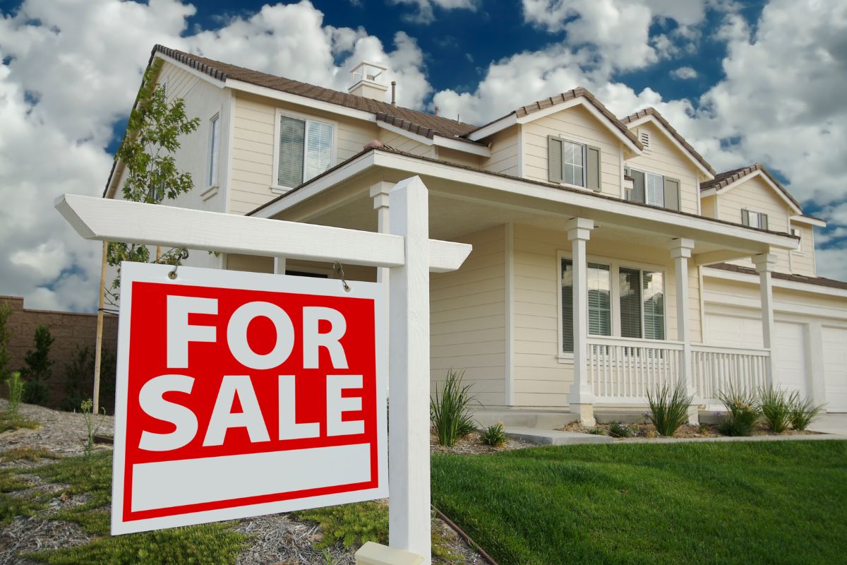 For sale sign in front yard of suburban home in Illinois representing Tri-Cities real estate market listing