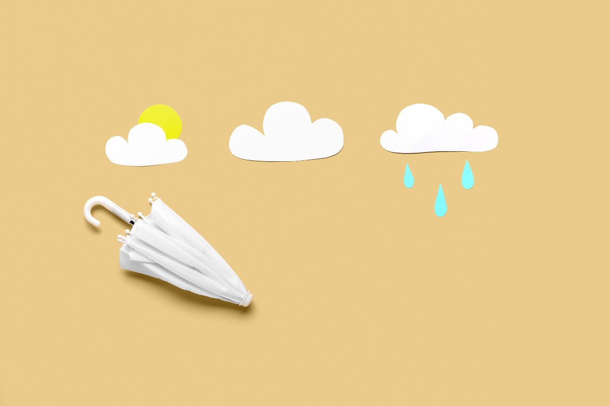 Late winter weather forecast illustration with clouds, rain, sun, and umbrella for Tri-Cities Illinois open houses in Batavia, Geneva, and St. Charles