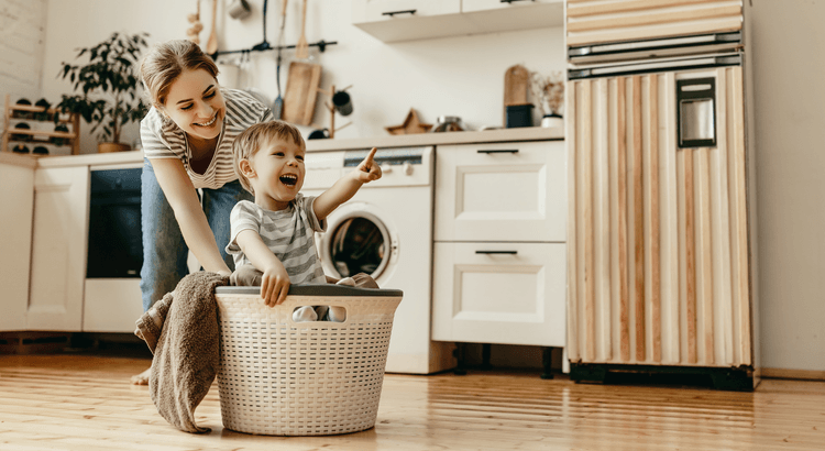 Parent and child playing together in the kitchen, representing the long-term value and benefits of homeownership.